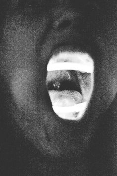 a black and white photo of a person's mouth