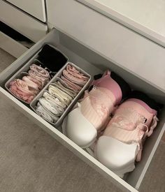 several pairs of shoes are in a drawer