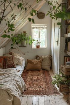 a bed sitting under a window next to a book shelf filled with lots of books