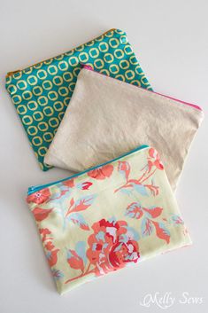 three zippered pouches sitting on top of each other