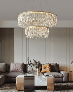 a living room with a couch, coffee table and chandelier hanging from the ceiling