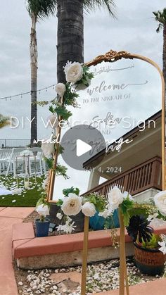 a mirror sitting on top of a wooden stand next to flowers and plants in front of a palm tree