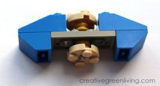 there is a lego blue car with gold wheels on it's head and the door open