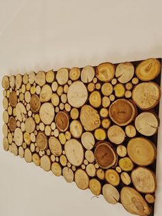 a group of wood slices arranged on top of each other in the shape of a wall hanging