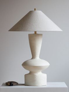 a white lamp sitting on top of a table