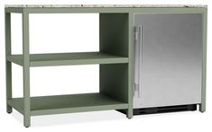 a green kitchen island with two shelves and a silver refrigerator freezer next to it