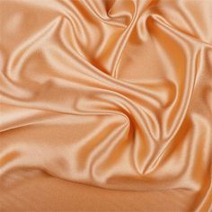 an orange satin fabric is shown in close up