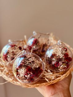 small glass ornaments with dried flowers in them