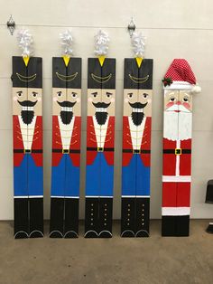 four wooden nutcrackers are lined up against the wall