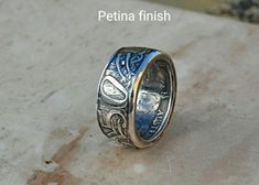 Very nice hand crafted coin ring made from a silver Australian 50 cent coin.  This ring would make an ideal 50th Birthday gift. All Of My Coin Rings are Hand Made, from genuine, circulated coins as such they all have a history and character of there own making each ring a totally unique one off creation. PLEASE MAKE SURE YOU ARE ORDERING THE CORRECT SIZED RING PLEASE DON'T GUESS!  I will resize rings. I only charge return post and packaging for the first resize, for any subsequent resizing I charge £10.00 plus p&p. All of my rings can be supplied with a polished or a petina finish. The antique petina is created by chemically oxidizing the surface of the metal. The colours created very from ring to ring making every ring unique. Unfortunately the petina is not permanent,  I do protect the p Coin Rings, Resize Ring, How To Make Rings, Coin Ring, 50th Birthday Gifts, 50 Cent, 50th Birthday, Unique Rings, Band Rings