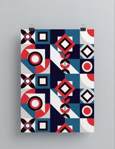 a square poster hanging on a wall with geometric shapes in red, white and blue