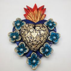 a blue and gold heart with flowers on it