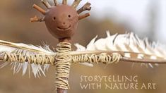 a brown toy with white feathers on it's head and eyes is sitting on top of a stick