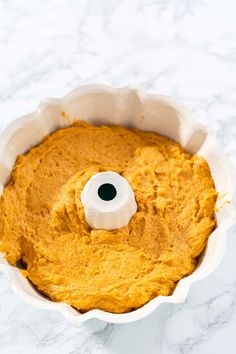 a food processor filled with sweet potatoes and topped with a white plastic eyeballshadow