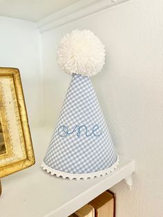 The Embroidered One Birthday Hat is the perfect accessory for a first birthday, photoshoot, or both!  It features "one" in a sweet cursive print embroidered on the fabric of your choice, rick rack, pleated ruffle, or white dot trim, and a fluffy handmade pom pom to top it off! It also has an elastic band that goes under the chin to keep it securely on your little one's head.  Hat measures approximately 8 inches tall (from the top of the Pom Pom to the bottom of the trim) by 5 inches wide (at the base)  **This hat can be made in any fabric or pom pom color! It can also be made in TWO instead of one! Please message me along with your order, if there is another fabric or color you would like! First Birthday Party Hat, Embroidered Birthday Hat, Birthday Corner, Disney Stroller Tags, Baby Birthday Hat, Disney Stroller, First Birthday Photoshoot, First Birthday Hat, Care Bear Birthday