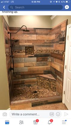 a bathroom with wood planks on the shower wall