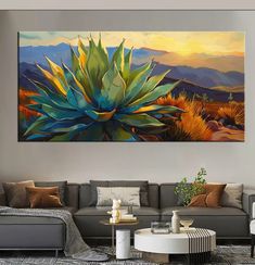 a living room with a large painting on the wall and couches in front of it