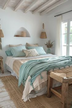 a bed sitting in a bedroom next to a window with lots of pillows on top of it