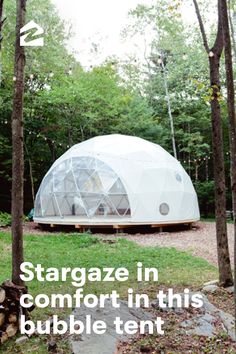 a large dome tent in the middle of some trees