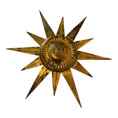 a gold metal sunburst with a face on it