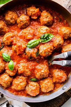 meatballs with tomato sauce and basil in a skillet