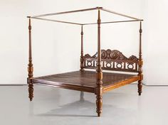 an antique wooden bed with four posts