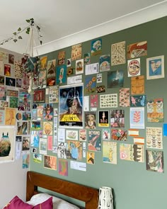 a bed with a wooden headboard and lots of posters on the wall