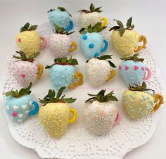 a white plate topped with chocolate covered strawberries and strawberry shaped candies on top of a doily