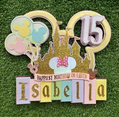 an image of a happy birthday sign on the grass with minnie mouse ears and balloons