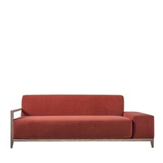 a red couch sitting on top of a white floor