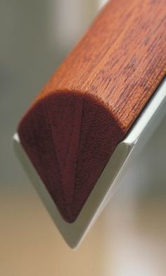 a close up view of a wood and metal window seal on a glass door frame