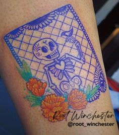 a tattoo on the arm of a woman with a skeleton and flowers in it's frame