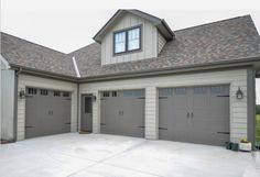 a large house with two garages and three windows