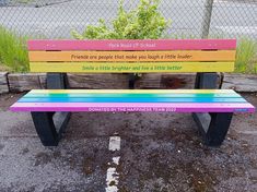 a colorful bench sitting in front of a chain link fence with the words friends are people that make you laugh at little brother