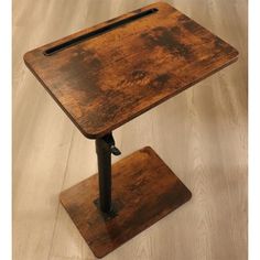 an old wooden table with metal legs and a square shaped tabletop on it's base