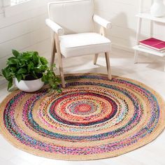 a white chair sitting on top of a rug in a room