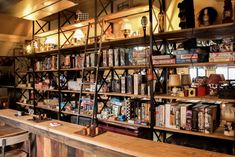 the shelves are full of books and magazines in this room that is filled with old - fashioned items