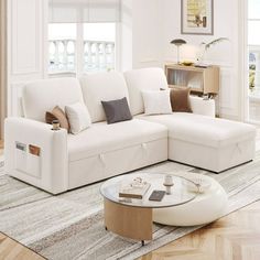 a living room with a sectional couch and coffee table on the rug in front of it