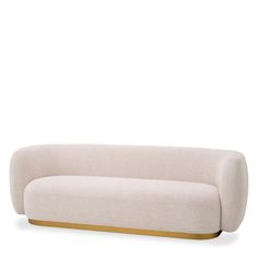 a white couch with gold trim on the bottom and back end, against a white background