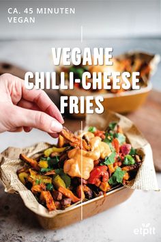 a person is dipping some food into a container with the words vegan chilli - cheese fries