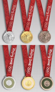 four olympic medals with red ribbons around them