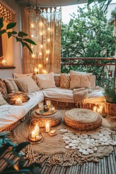 a living room filled with lots of furniture and candles on top of a rug next to a window