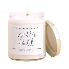 a white candle that says, sweet water decor hello fall on the front and inside