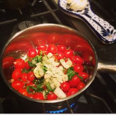 tomatoes, onions and parsley in a pot on the stove