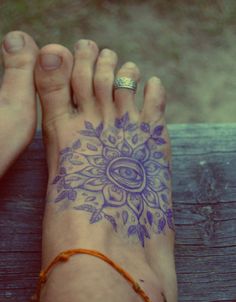 a woman's foot with a tattoo on it