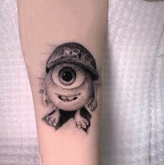 a black and white photo of a person with a hat on their arm that has an eyeball in it