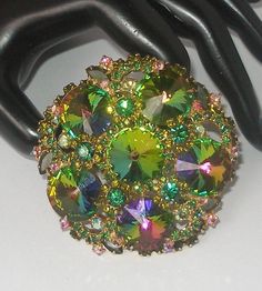 "Offering a Rare fabulous Juliana D & E Watermelon Rivoli Brooch.  This beautiful vintage brooch makes a statement and is a massive 3\".  There are six gorgeous Watermelon  Rivoli crystals accented with Olivine crystal florets, and clusters of round Emerald green and iridescent AB Crystals.  It is set in a gold metal and the craftsmanship is undeniably unmarked \"JULIANA\".   About Juliana D & E vintage jewelry:  The name \"Juliana\"is synonymous with jewelry made by DeLizza and Elster.  In the late 60s, Their magnificent designer jewelry pieces were originally marked only with paper hang tags.  This is one of those awesome pieces from their select group of savvy costume jewelry.  This is truly a collector's item and absolutely gorgeous!  The pictures don't really do it justice...It won't Juliana Jewelry Vintage, Juliana Jewelry, 1960s Dresses, 1960s Jewelry, Crystal Brooch, I Love Jewelry, Vintage Brooch, Vintage Costume Jewelry, Vintage Jewellery