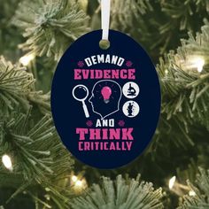 a christmas ornament with the words, demand evidence and think critically on it