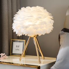 Decorate your room and complete it with a tropical-inspired tree shape Brauer Feather Bedroom Table Lamp. The body is masterfully shaped and decorated with leaf-like ostrich feathers on top to create luxury motives in your space. Thanks to gaps between the feathers the light is filtered nicely to illuminate softly and warmly to create a cozy atmosphere. Brauer Lamp makes an outstanding feature piece in your home. Details Material: feather + metalFeather color: white, pink, ,Light pink,Ink blue,r Night Stand Light, Bedside Lamp Modern, Feather Lamp, Nightstand Light, Book Lamp, Tripod Table Lamp, Прикроватные Тумбочки, Bedroom Bedside Lamp, Modern Bedside