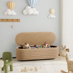 a toy storage box in the middle of a playroom with toys on the floor